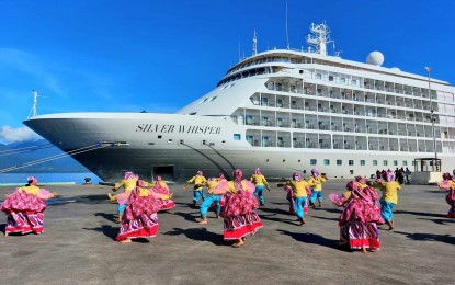 Folk dancers hired by the City Tourism Department welcome the passengers and crew of the luxury cruise ship MS Silver Whisper as it arrives in Puerto Princesa.